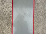 a mirror on the side of a building with a red border