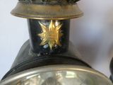 a close up of a clock with a gold star on the top of it