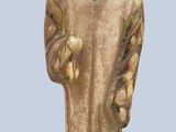 a statue of a man with a hat holding a banana
