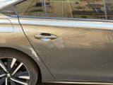 a silver car parked on the side of the street