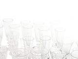 a lot of glasses that are lined up on the table