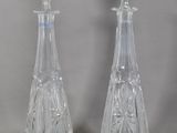 pair of cut glass decanters on a grey background