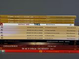 many books stacked on top of each other on a table