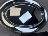 a silver plate with a piece of paper sticking out of it