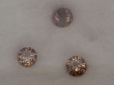 Trois diamants chocolat de taille brillant.
