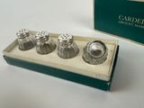 four salt and pepper shakers in a box