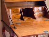a wooden desk with a drawer on top of it