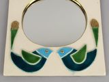 a picture of a mirror with two birds on it
