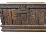an old wooden chest with carvings and carvings on the sides