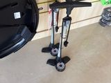 a black and orange scooter sitting next to a black and orange scooter