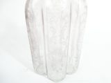 a clear glass vase with a floral design on it