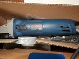 a bosch electric sander in a box with other tools