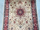 an oriental rug with a red border and floral design