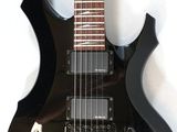 a picture of a black electric guitar hanging on a wall