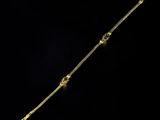 an image of a gold bracelet on a black background