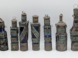 several bottles of wine are lined up in a row on a white surface