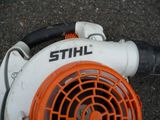 an orange and white blower sitting on the ground