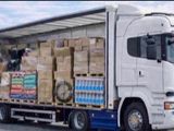 a semi truck with a large load of boxes on the back of it