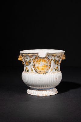 an image of a white and gold vase sitting on top of a table