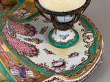 a very ornately decorated table with a candle on it