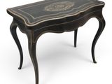 a small black table with a gold decoration on the top