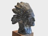 statue of a native american indian head on a wooden base