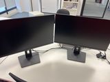 two monitors sitting on a desk with a mouse on it
