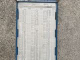 a close up of a blue and white sign on a cement floor