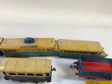 several toy trains are lined up on a white surface