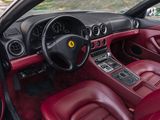the interior of a red sports car with red leather seats