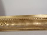 a picture of a gold picture frame on the wall