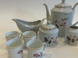 a lot of cups and a teapot on the table