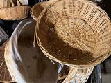 a pile of wicker baskets sitting on top of a table