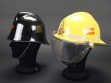 two helmets are sitting on top of each other on a black surface