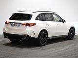 the rear end of a white mercedes suv on a checkered floor