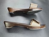 two pairs of wooden shoes are sitting on a gray surface