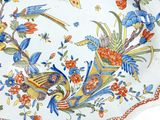 a plate with a bird and flowers on it