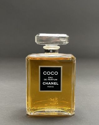 a close up of a bottle of perfume on a table