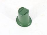 a close up of a green plastic object on a white surface