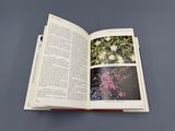 an open book with pictures of flowers on it