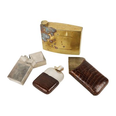 three pieces of leather and metal are sitting next to each other