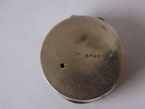 an antique silver plate with a small hole in the middle