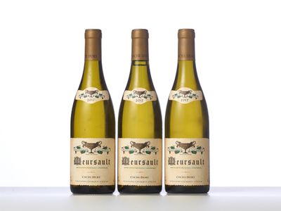 three bottles of white wine sitting on top of a table