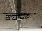 four lights hanging from the ceiling of a building