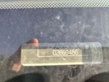 a person holding up a sign in the back of a car