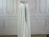 a photo of a white dress on a mannequin stand