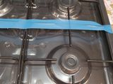 a black stove with a blue ribbon on it