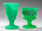 deux verres à pied en verre vert posés l'un à côté de l'autre