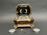 a small box that has a coin in front of it