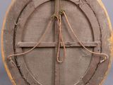 an image of a round wooden object with a rope hanging from it